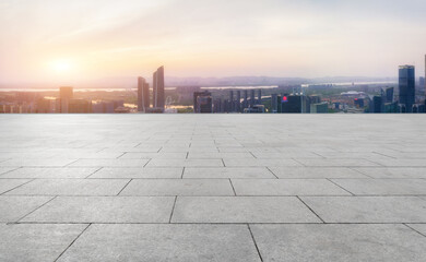 Fototapeta premium Panoramic skyline and empty square floor tiles with modern buildings