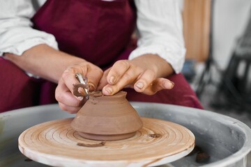 making ceramic pottery on a potter's wheel