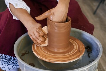 Fototapeta na wymiar making ceramic pottery on a potter's wheel close-up