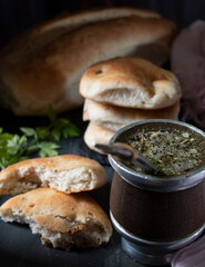 infusion based on yerba mate. Cakes with pork rinds and bread. Concept of traditional food from Argentina based on flour and frying of pork with skin.
