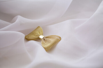 gold bow, women's hairpin, white background