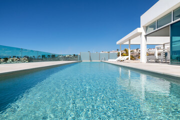 Luxurious property with an infinity swimming pool surrounded by a spacious terrace with views...