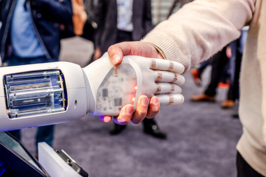 Human hand and robot's as a symbol of connection between people and artificial intelligence technology