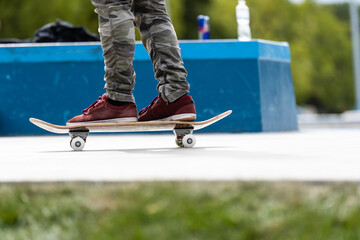 Close up of a skateboarders feet while skating on concrete at the skate park