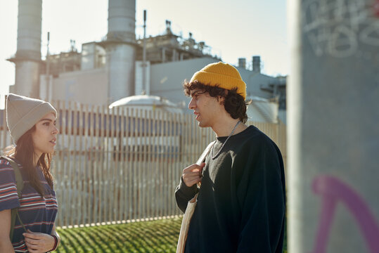 Two talkative young people having a chat outside - Powered by Adobe