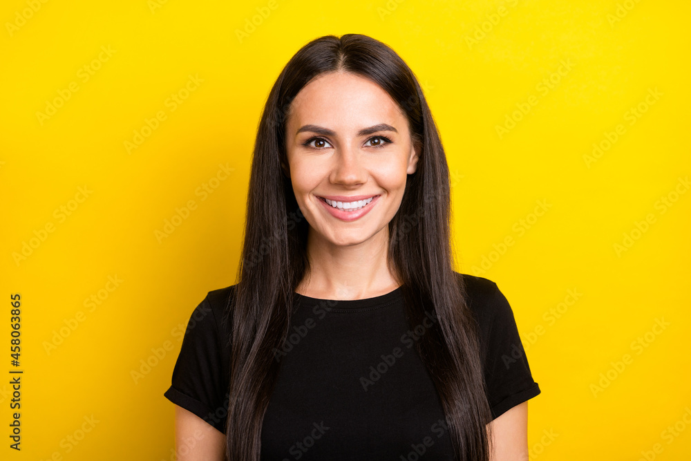 Poster Photo portrait of pretty woman smiling cheerful wearing black t-shirt isolated on vivid yellow color background