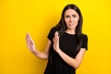 Photo portrait of girl in black t-shirt disgusted refusing ignoring isolated vibrant yellow color...