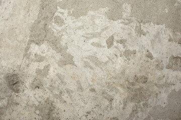 An old cement wall with traces of destruction and aging