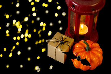 Halloween. Festive autumn decorations. Lantern, pumpkin, bat and gift box on a black background. Decor concept for halloween celebration. Copy space. - 458065686
