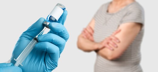 Medical doctor hand in medical gloves holding a syringe.