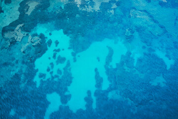 Fototapeta na wymiar vertical aerial view of some submerged rocks off the coast of tuscan talamone