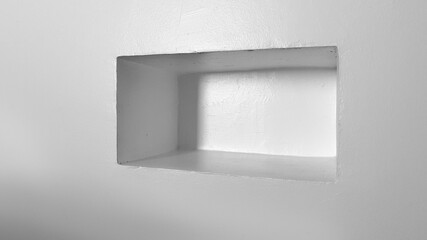 White wall with box shelf. Simple and minimalist decor  architecture. All white texture. Minimal background.