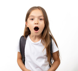 Student girl kid on white background looking at camera with surprised facial expression.