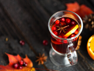 autumn mulled wine. Alcoholic spicy drink made of red wine orange, cinnamon, cloves, anise and lingonberry berries