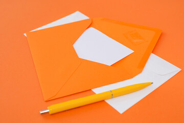 envelope with a pen on an orange background.