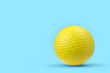 Yellow golf ball isolated on blue background