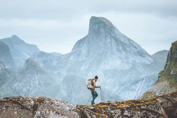 Tuinposter Man hiking in mountains traveling solo with backpack outdoor active vacations in Norway healthy lifestyle extreme sports © EVERST