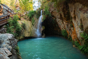 Fototapeta na wymiar Beautiful waterfalls Degirmendere Selalesi in the nature of Side in Turkey with beautiful colors in the rocks. GIZLI CENNET