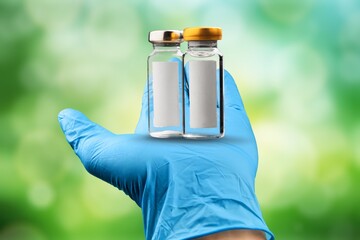 Doctor or scientist holding a syringe with liquid vaccines booster.