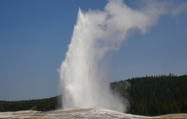 Natural view of water splashes up in the air under a ckear blue sky