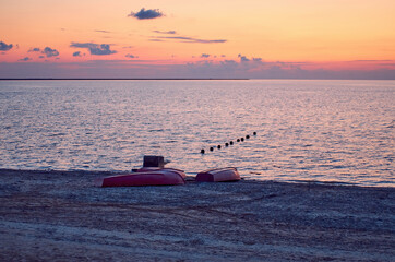inverted red boat on the beach. landscape postcard. background. blank for designer, illustrator,...