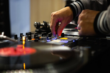 Hip hop dj mix musical tracks on sound mixer device. Professional disc jockey mixing music