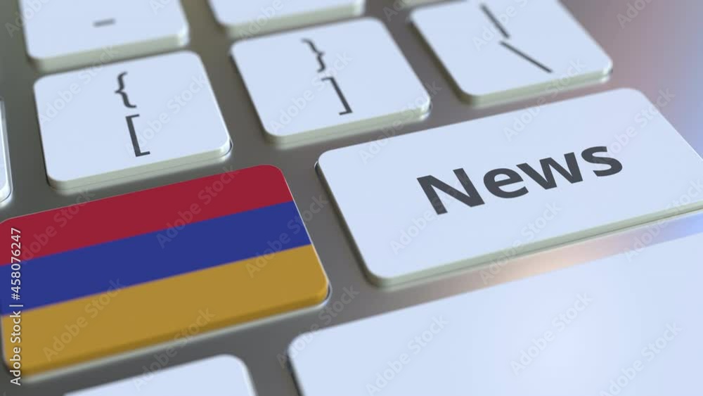 Aufkleber news text and flag of armenia on the keys of a computer keyboard. national online media related conc
