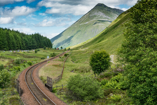 Along the West highland Way in Scotland. a view of the Milngavie - Fort William railway line and of Beinn Dorain mountain