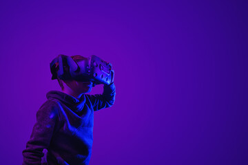 Child with virtual reality glasses in 3D environment