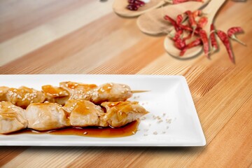 Grilled tasty cheese on a wooden board with sugar syrup and pepper.