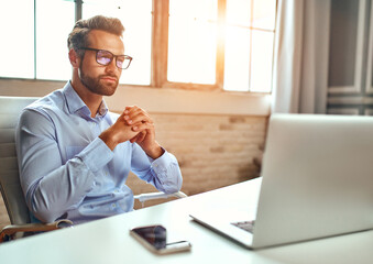 A man in a shirt and glasses is talking on a video call, an online business conference, a meeting....