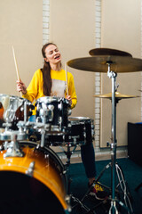  woman enjoying drumming rhythmic beat 