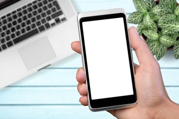 Human hands hold the phone with a blank screen