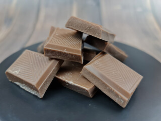 The Chocolate close-up. Pieces of natural chocolate. Milk chocolate.