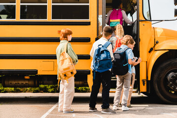 Summer holidays are over.Schoolchildren kids pupils group of mixed-race classmates boarding school...