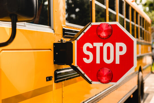 Yellow school bus. Stop sign. Be careful, schoolchildren crossing the road. New academic year semester. Welcome back to school. Lockdown, distance remote education learning