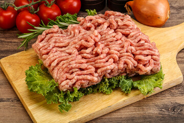 Raw pork minced meat over board