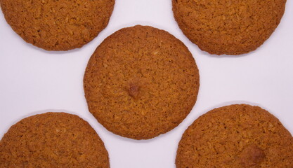 5 oatmeal cookies on a light background, focus in the center