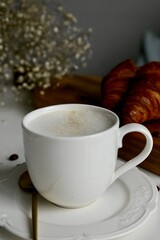 cup of coffee and croissant in the morning breakfast