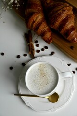 cup of coffee with croissant