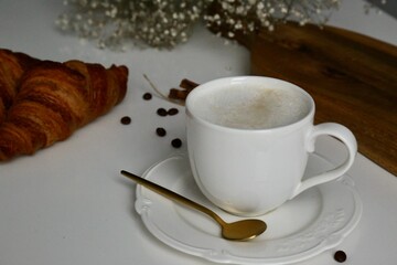 cup of coffee and croissants in the wood desk in the french breakfast 