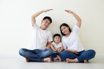 Asian family smiling and playing house by hand on isolated white background. Family with new home concept