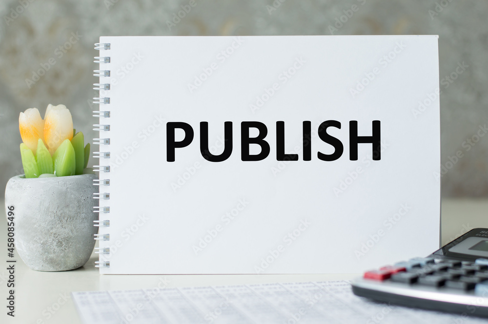 Aufkleber on the desktop a notebook with the text publish. business concept