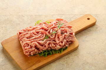 Raw minced pork meat over board