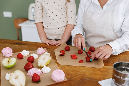 Cropped Chef Cook Baker Mom Woman In White Shirt Work With Child Baby Girl Helper Learn Cutting Berries At Kitchen Table Home Cooking Food Process Concept Mommy Little Kid Daughter Prepare Fruit Cake