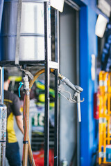 Gas nozzle with one last drop. Gasoline nozzle on a blur background. Refill and filling Oil Gas Fuel on blur background. Gas station - refueling. To fill the machine with fuel. 