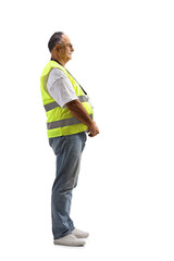 Full length profile shot of a mature security officer in a safety vest standing
