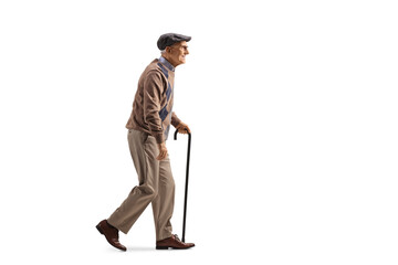 Full length profile shot of an elderly man with a walking cane in his hand