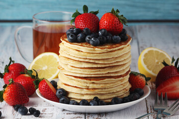 A stack if home-made pancakes with berry