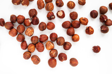 Fresh peeled Hazelnuts, without their hard brown shells. Hulled nuts flat lay composition on a white background.